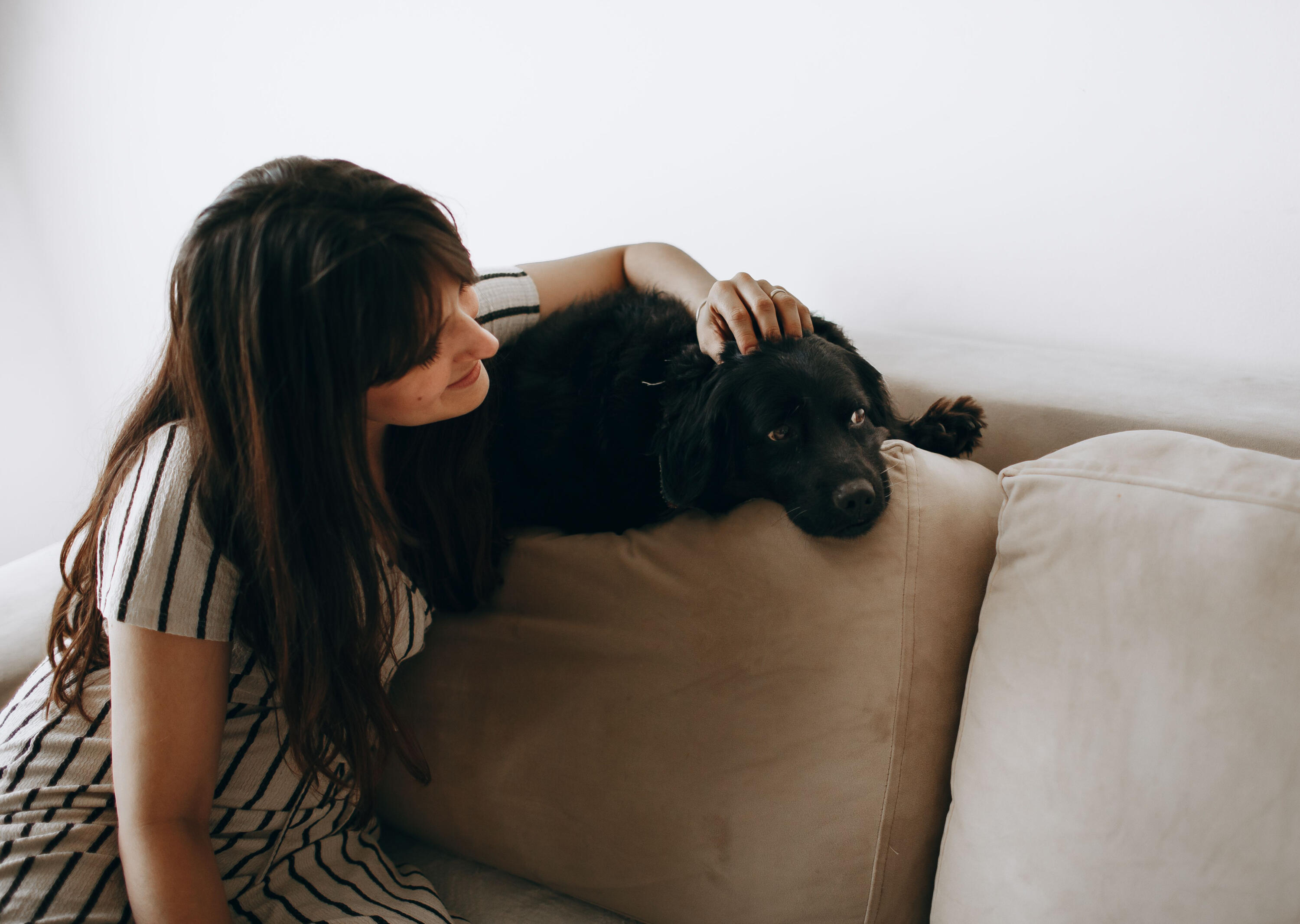 Woman sitting with her dog at home